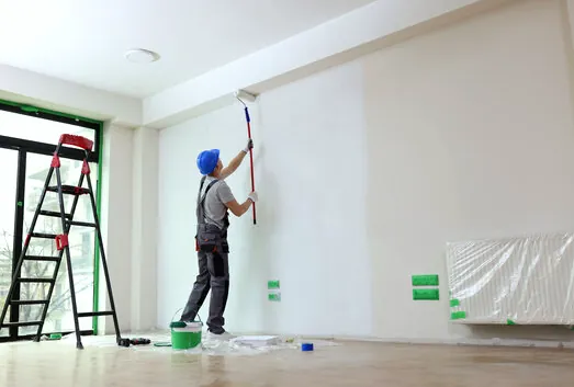 Painter rolling fresh white paint in an empty unit during a Gardena rental turnover